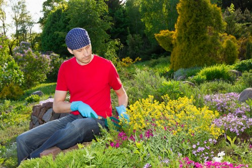 Operative wearing PPE operating garden equipment